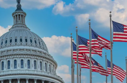 The Capitol building and flags, symbolizing financial management and analysis for defense initiatives.