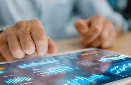 Person reviewing business data visualizations on a tablet with charts and graphs, representing administrative support for analytics and reporting — Beacon Hill Associates staffing for business operations and administrative analytics roles.