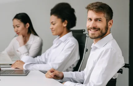 Three professionals meeting at a conference table, representing administrative support for family office operations.