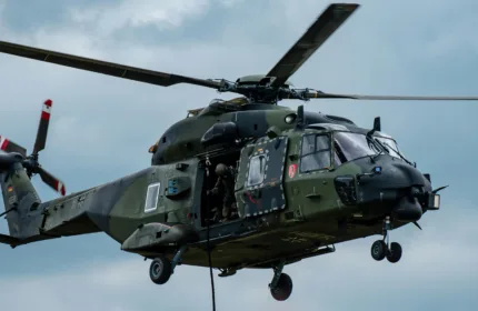 A helicopter preparing for takeoff, symbolizing HR and staffing support for defense contractors.